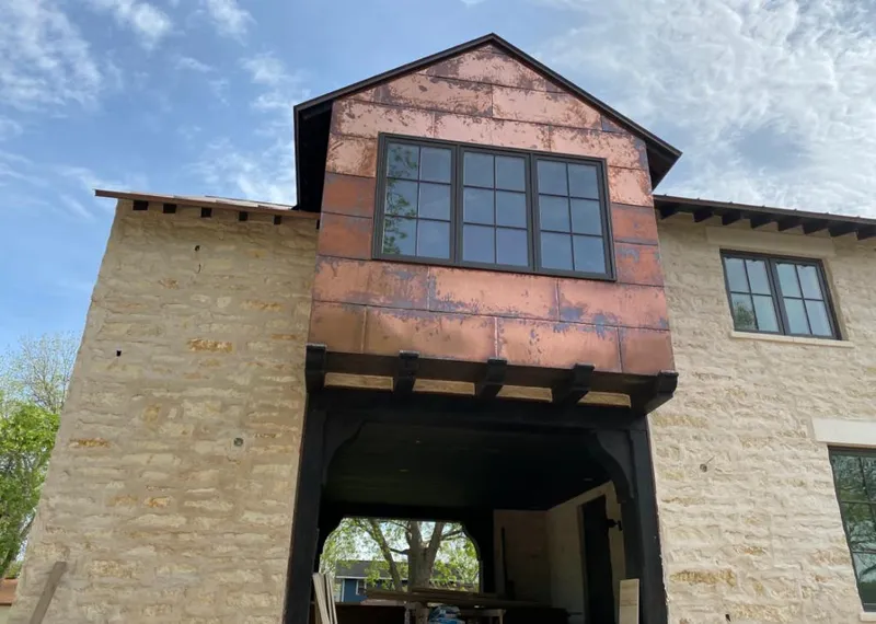 Copper metal panel facade on a stone building for Roof Repair in Heber